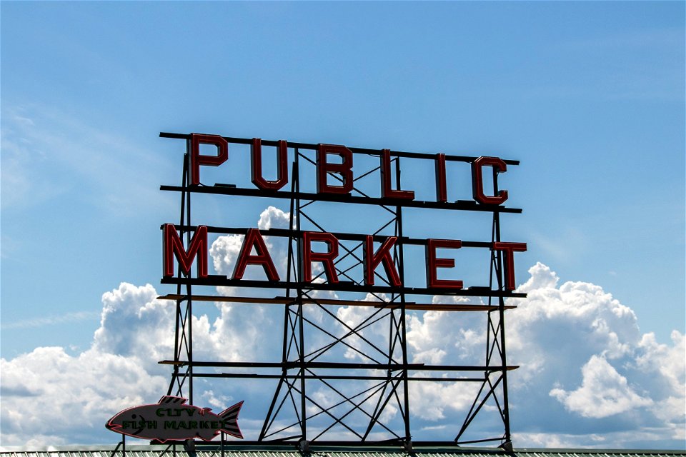 Unlit Public Market Neon Sign Against Clouds