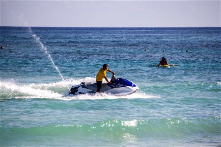 Man Riding Water Scooter On Water photo