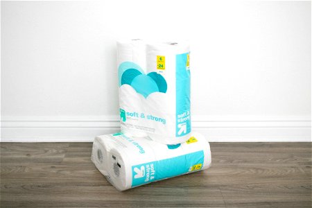 Packaged Toilet Paper Rolls On Wooden Floor