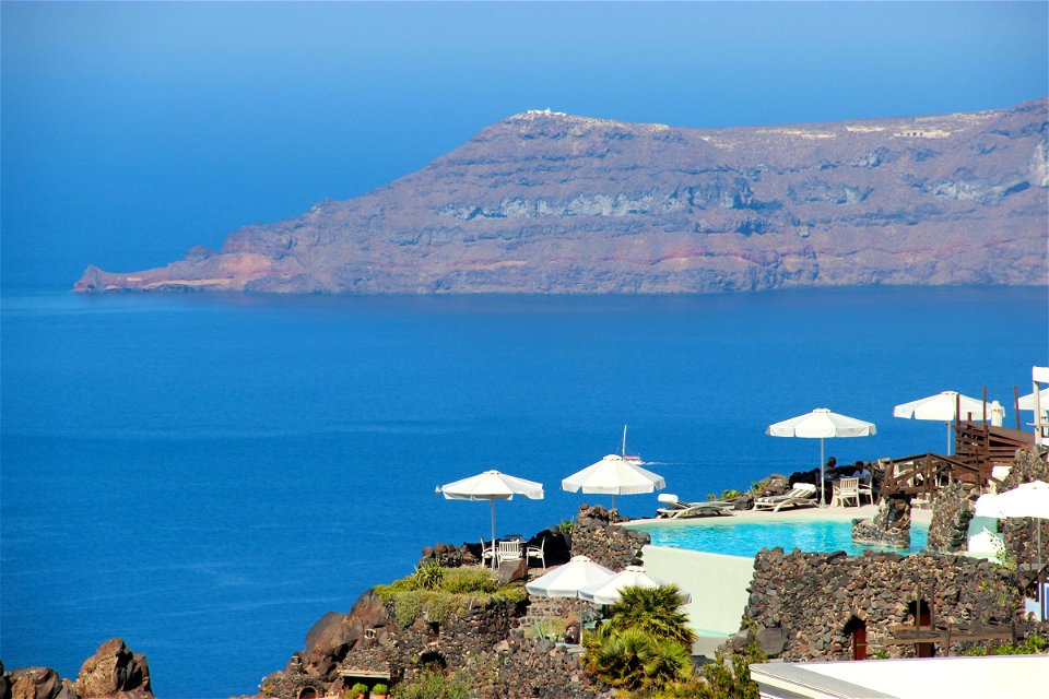 Mountain And Sea Behind Restaurant Near Cliff In Santorini photo