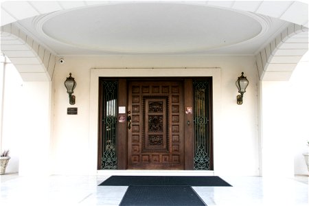 Mahogany Front Door Of White Historic Mansion photo