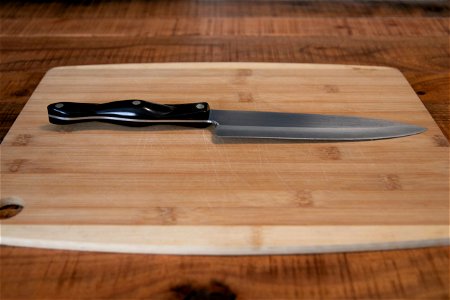 Knife On Wooden Chopping Board photo