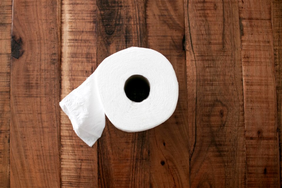 Toilet Paper Roll On Wooden Surface
