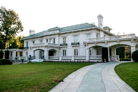 Side Walkway Leading To Large White Mansion