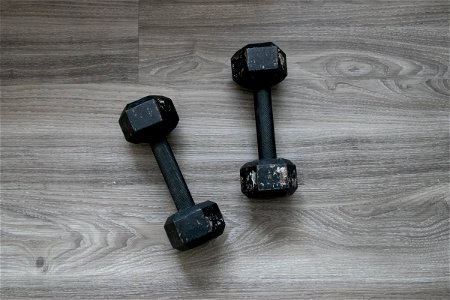 Cast Iron Dumbbells On Wooden Surface