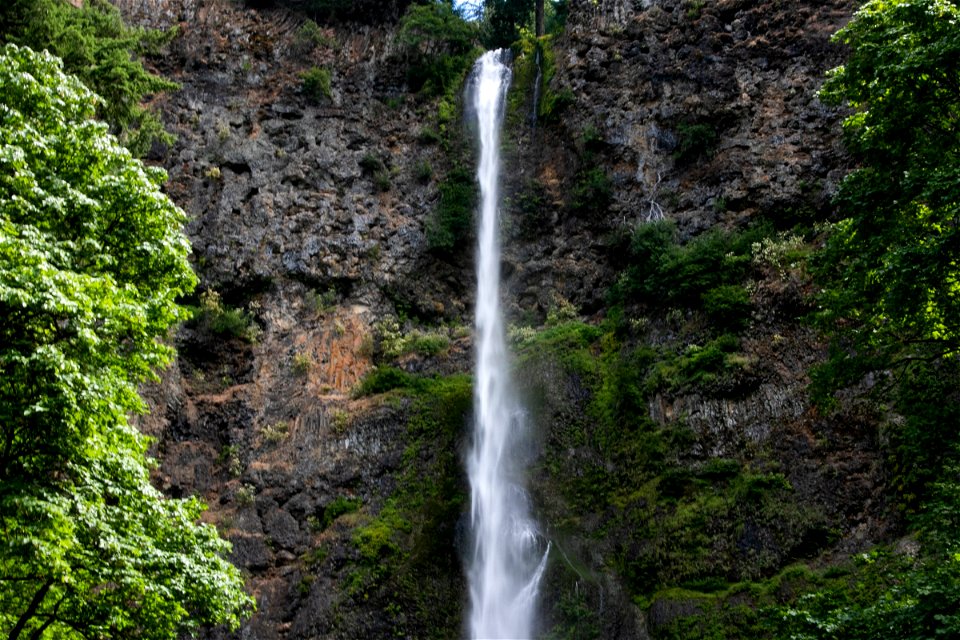 Thin Waterfall From Rock Mountain Cliff photo