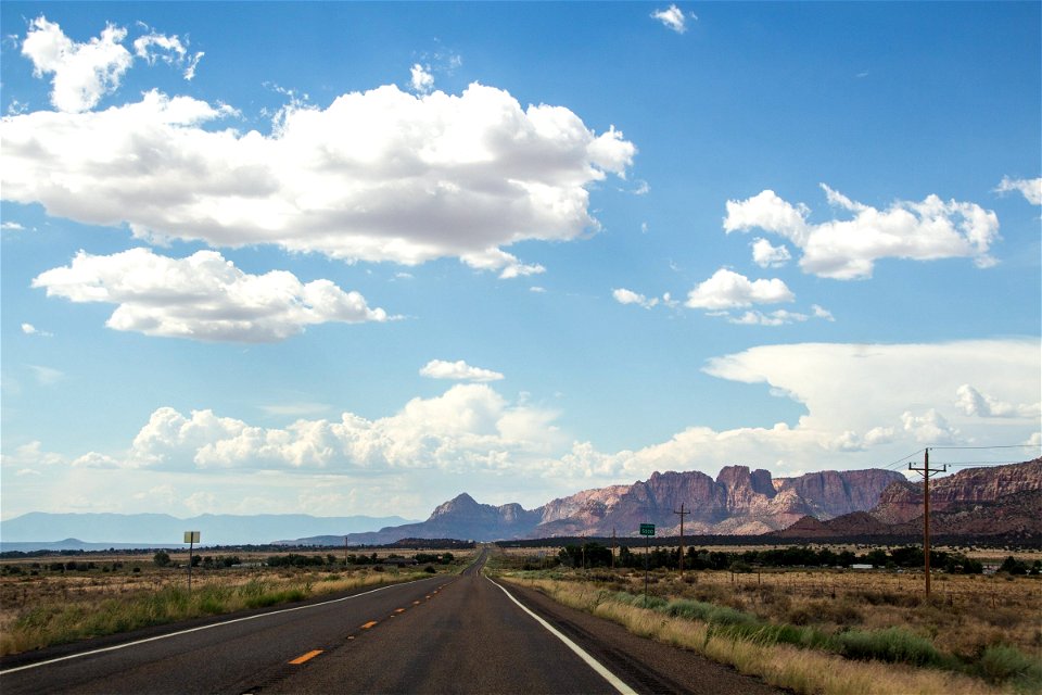 Empty Stretched Desert Road To Mountains