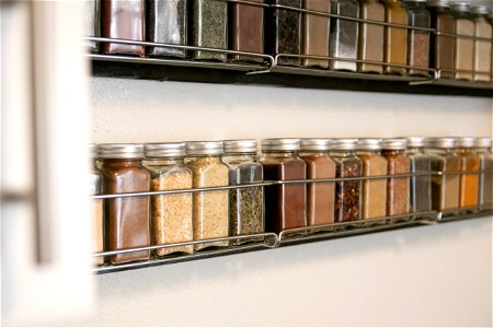Filled Jars In Wall Mounted Spice Rack