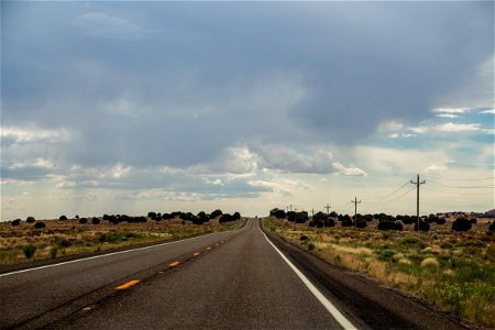 Empty Desert Road Under Cloudy Sky photo