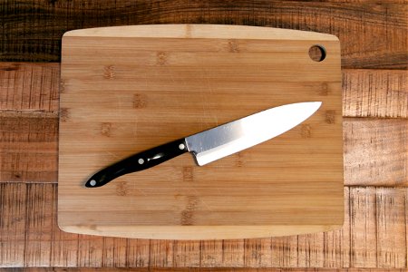 Knife On Wooden Cutting Board photo