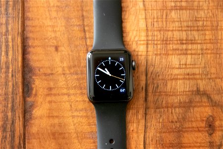 Dark Strapped Smart Watch On Wooden Surface