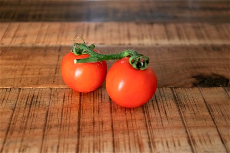 Two Tomatoes On Wooden Surface photo