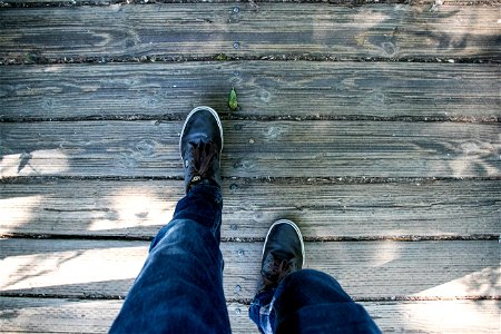 Walking Human Legs On Wooden Boardwalk photo