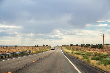 Vehicles In Two-Lane Desert Road photo