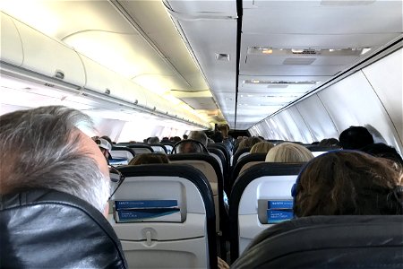 Rows Of Passengers Sitting On Plane photo