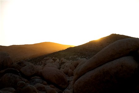Sunset Behind Hills Near Rocks And Boulders photo