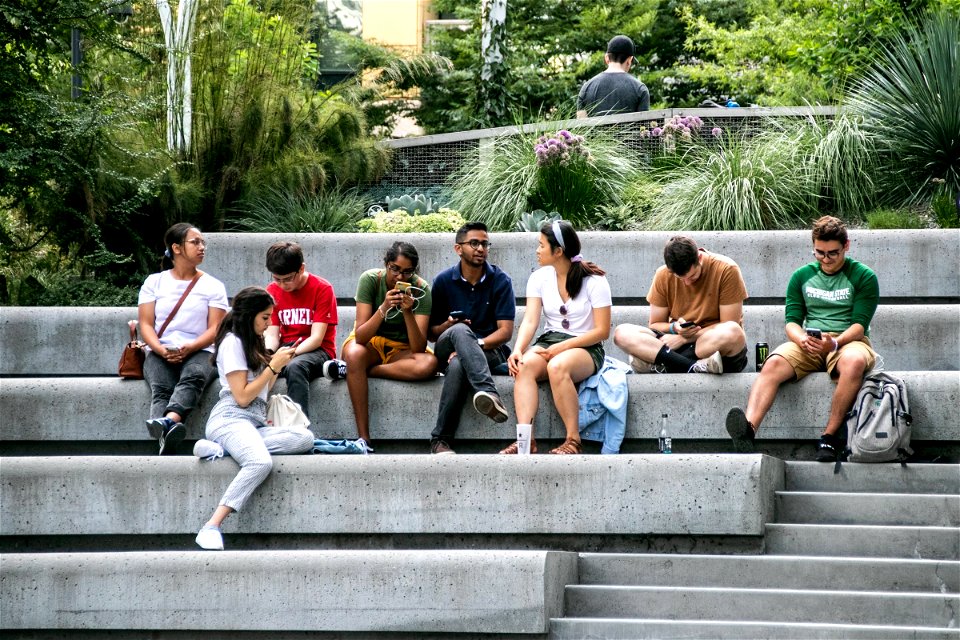 Group Of People Sitting On Concrete Steps photo