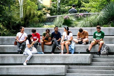 Group Of People Sitting On Concrete Steps