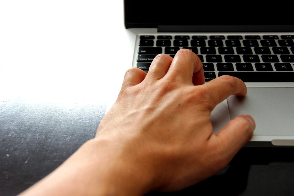 Left Hand On Laptop Trackpad