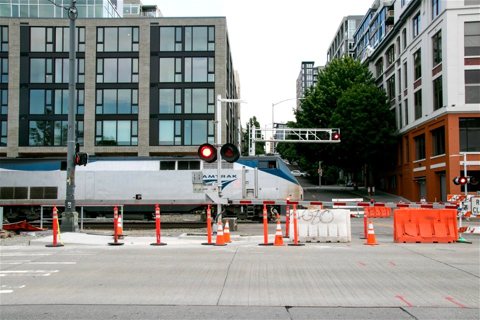 Train Moving On Rails Near Buildings