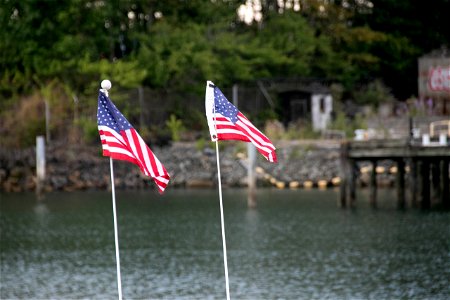 Two Small American Flags Near Water