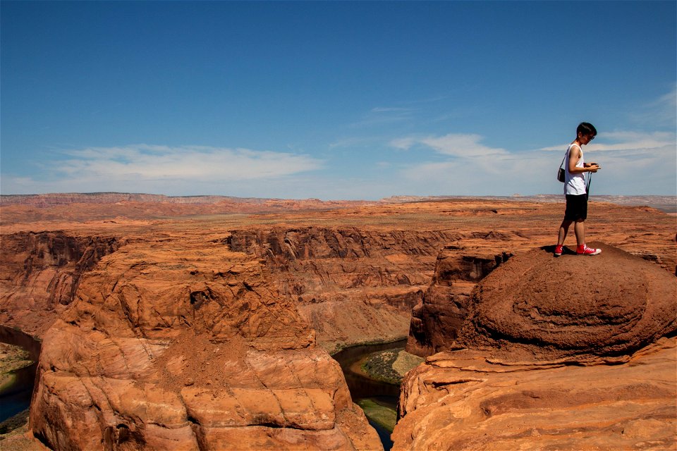 Man On Top Of Rock Formation In Horseshoe Bend