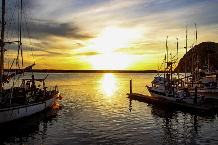 Sunset Between Boats In Morro Bay Harbor photo