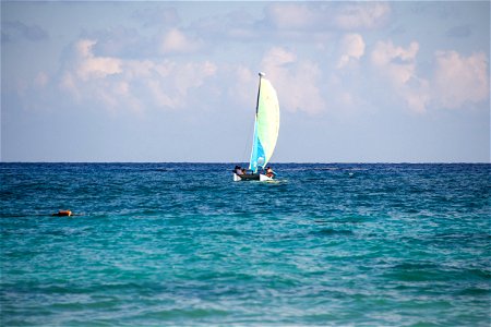 People On Small Sailboat On Water photo