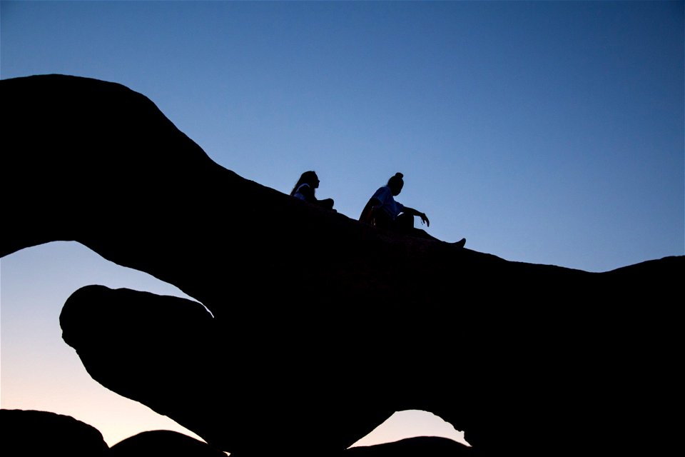 Two Women On Top Of Rock Formation photo