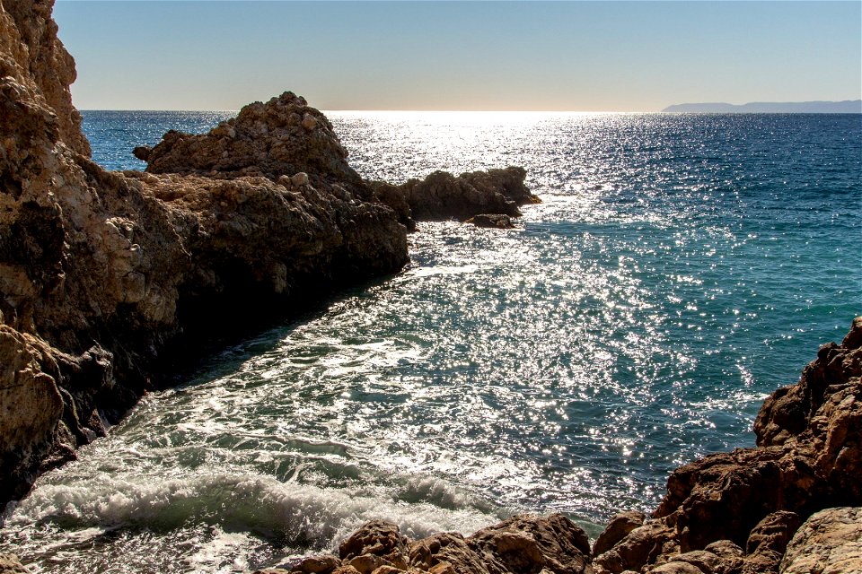 Rough Rocks On Edge Of Water Near Trail