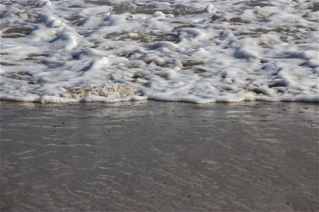 Sea Foam Receding To Water