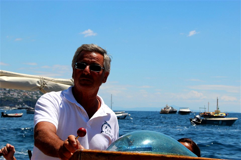 Man On Sailboat On Water Near Shore photo