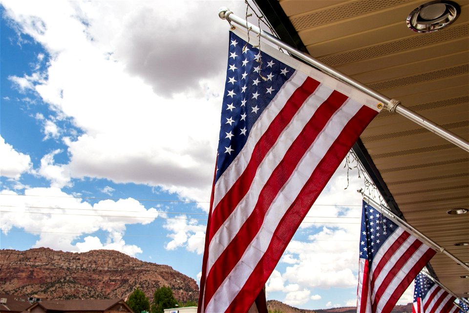 American Flags Under Portico Near Mountains