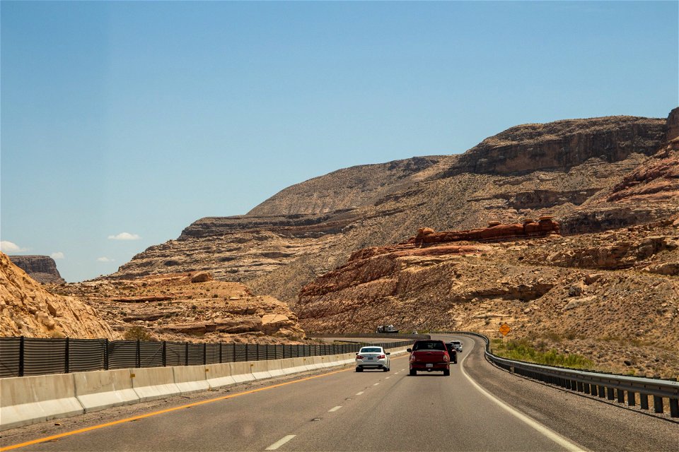 Vehicles In Highway Between Mountains photo