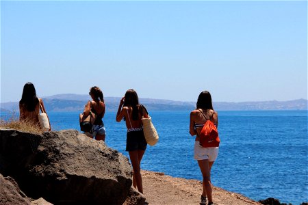 Women Walking Near Cliff Edge photo