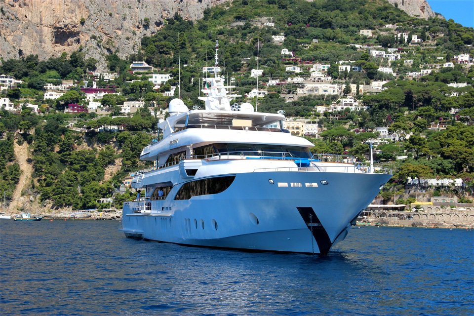 Ship In Water Near Coastal Cliff Village photo