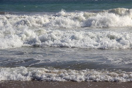 Waves Crashing On Sandy Shore