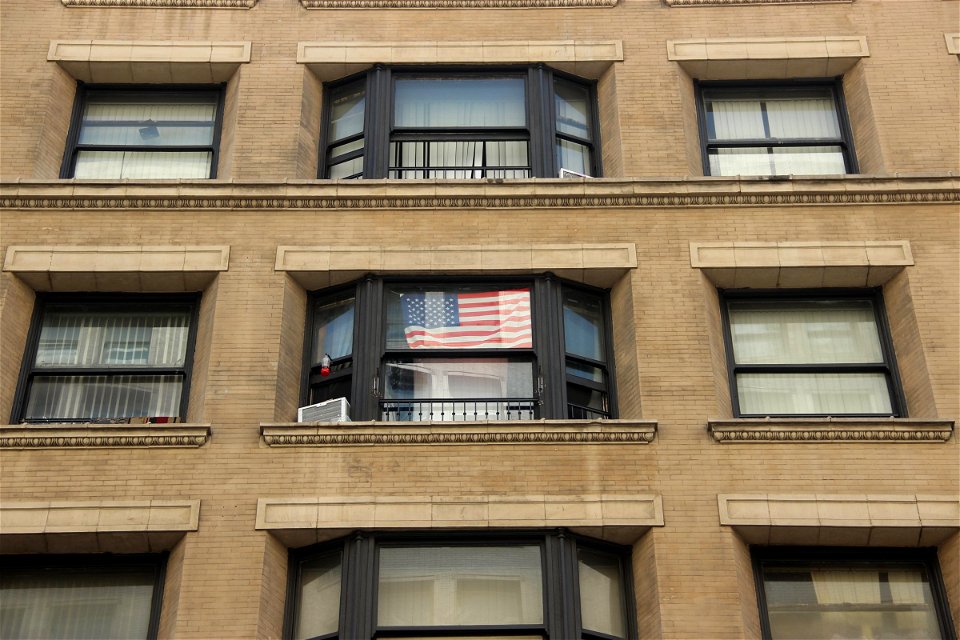 American Flag In Building Window photo