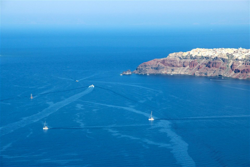 Various Boats Near Santorini Shore photo