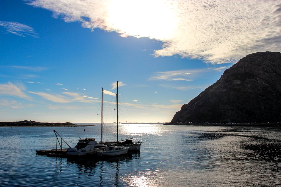 Still Sailboats In Water Near Mountain