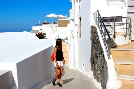 Woman In Alley In Santorini Island