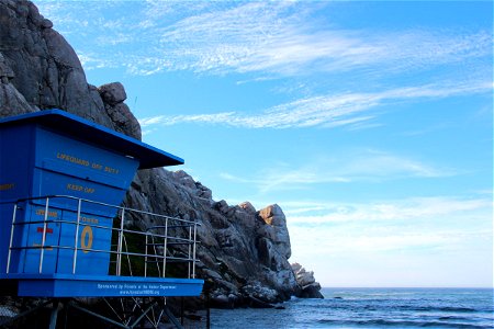 Lifeguard Tower Near Rocky Cliff photo