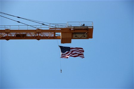 American Flag Swinging From Crane