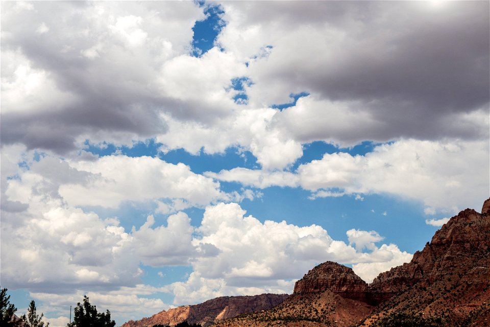 Puffy White Clouds Above Mountains
