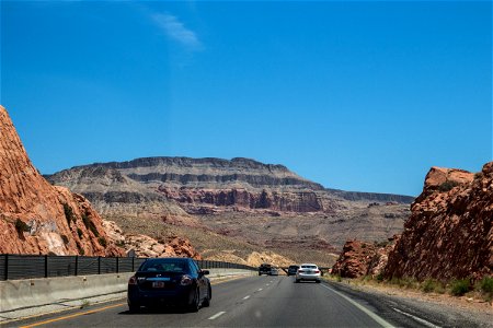 Vehicles On Desert Road Headed For Mountains