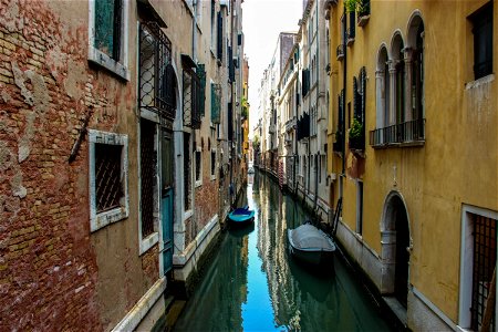 Boats Between Buildings In Narrow Canal photo
