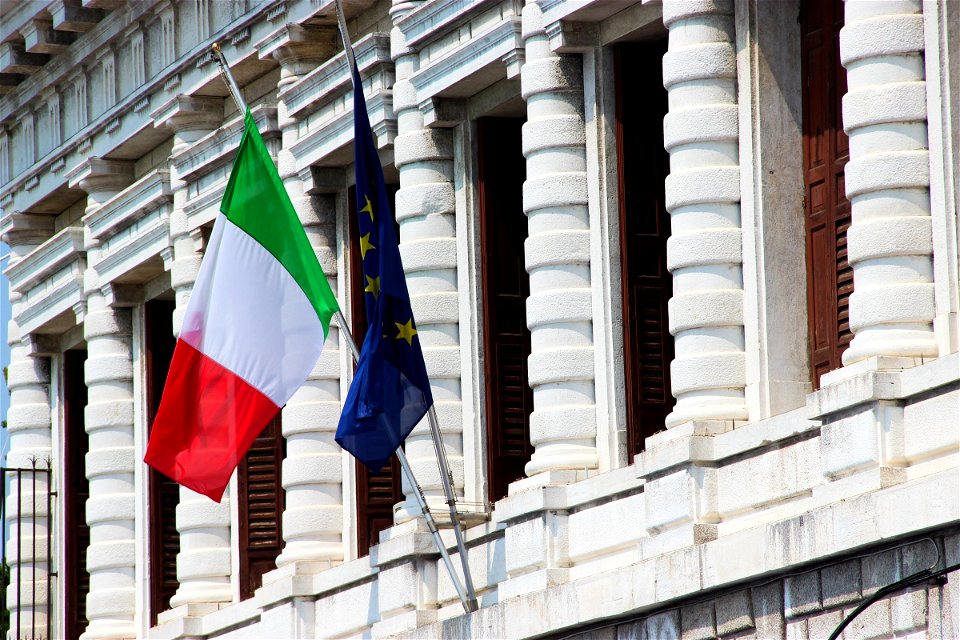 Two Flags On Old Building