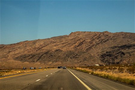 Cars In Desert Expressway Heading To Mountains photo