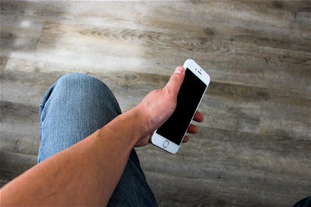 Phone In Left Hand On Leg