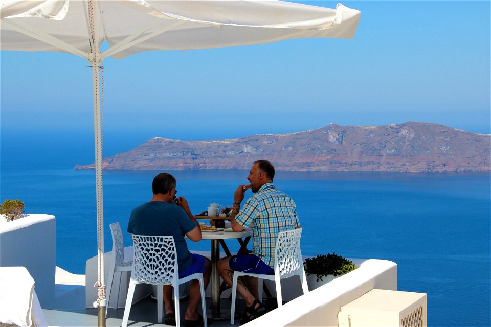 Two Men Eating With Sea View
